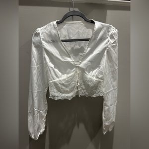 Beautiful white lace long sleeve top. No size on it but fits like a small